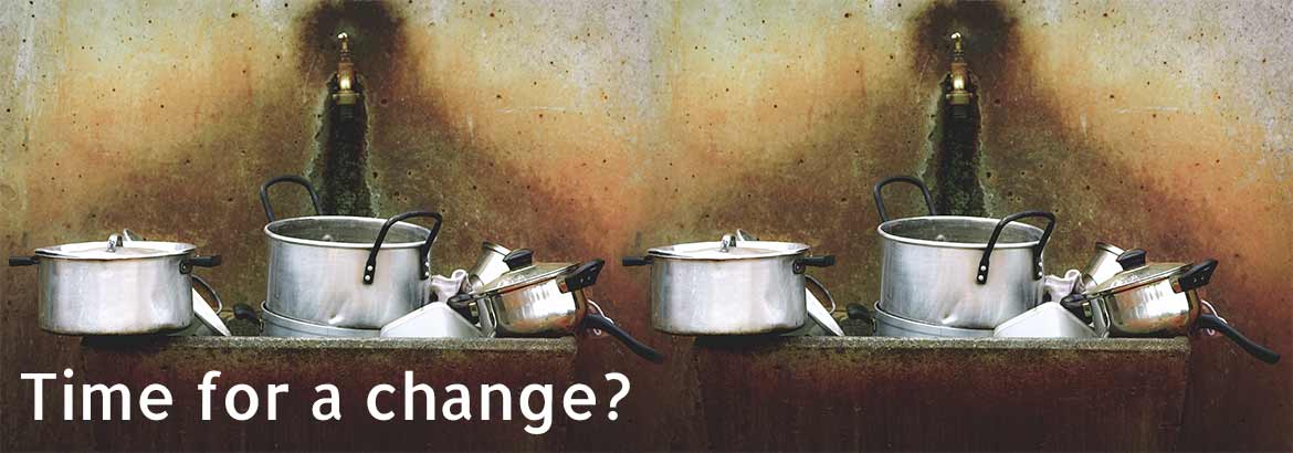 Traditional cooking pots beside a modern kitchen